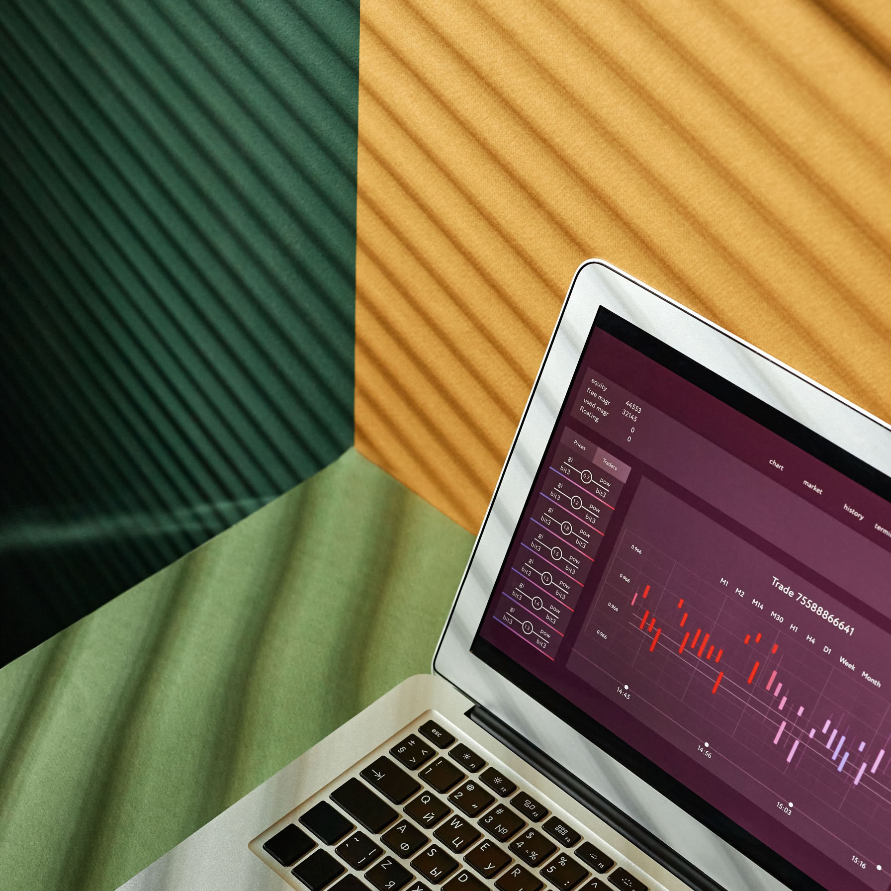A close-up of a laptop displaying data visualization on a colorful background.